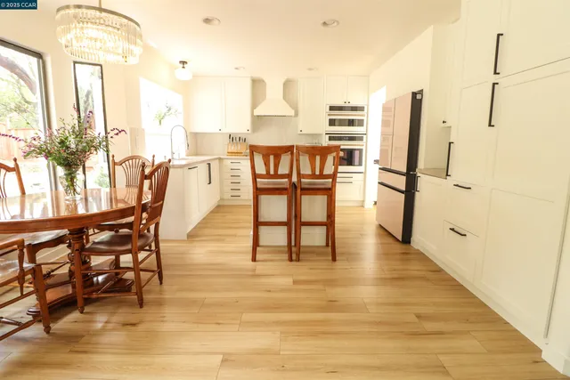 a dining room with furniture and wooden floor
