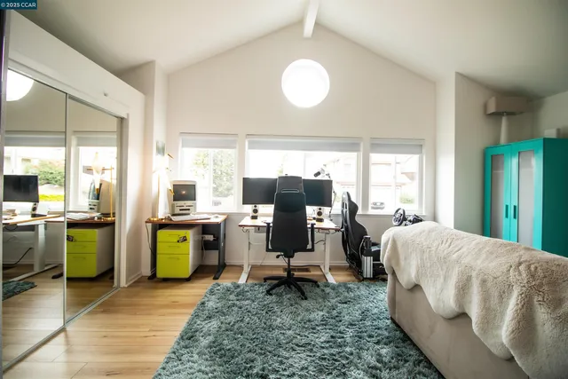 a living room with furniture kitchen view and large windows