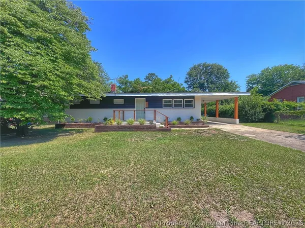 a view of a house with backyard porch and furniture