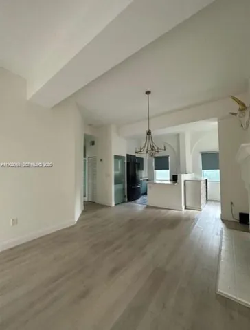 a view of a kitchen with a sink and a window