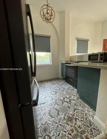 a room with a refrigerator and cabinets