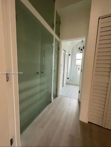 a view of a bathroom from a hallway