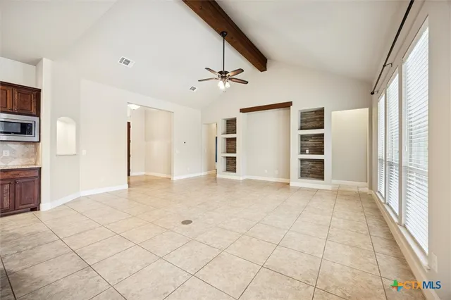 a view of a kitchen with a sink and a refrigerator
