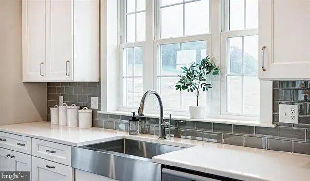 a kitchen with stainless steel appliances granite countertop a sink and a window