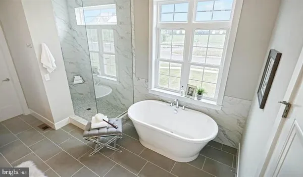a white bath tub sitting next to a white toilet