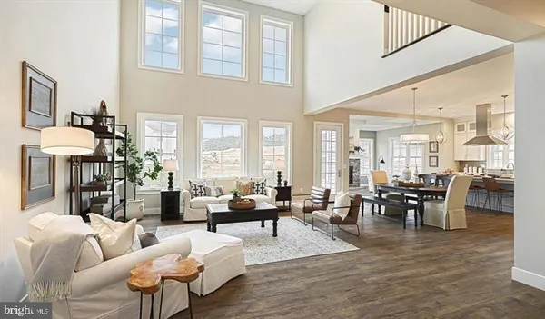 a living room with furniture dining table and a large window