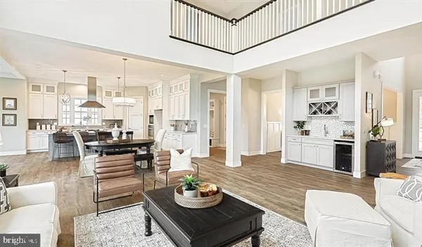 a living room with furniture kitchen view and a table