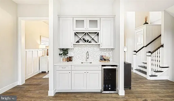 a view of cabinets a center island wooden floor and a window