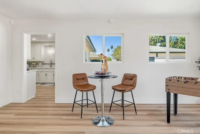 a view of a kitchen with dining table and chairs