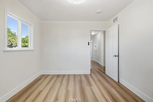 a view of a room with wooden floor and windows