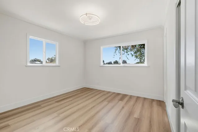 a view of room with window and hardwood floor