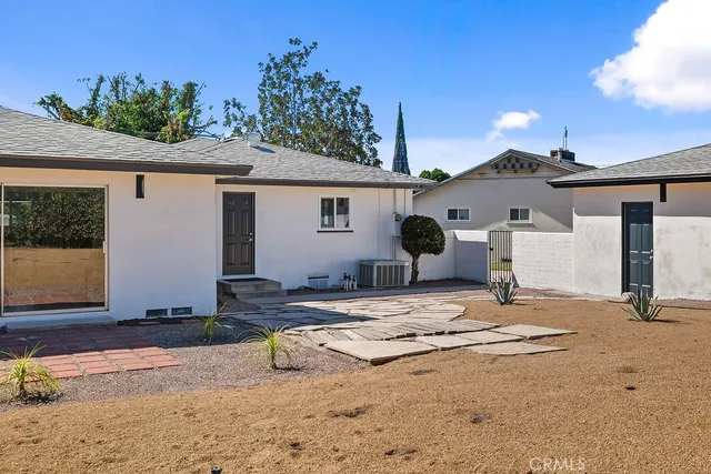 a view of garage with a patio