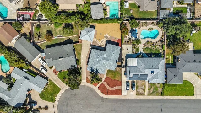 an aerial view of residential houses with outdoor space