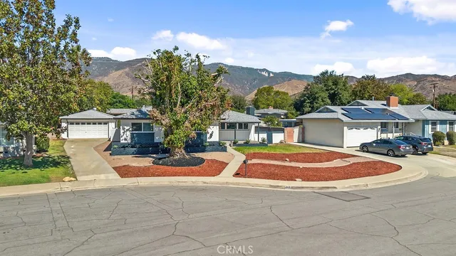 a front view of a house with a yard and a garage
