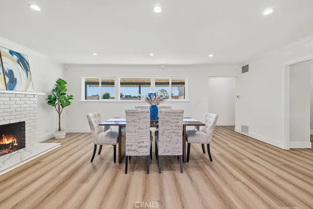 a dining room with furniture and wooden floor