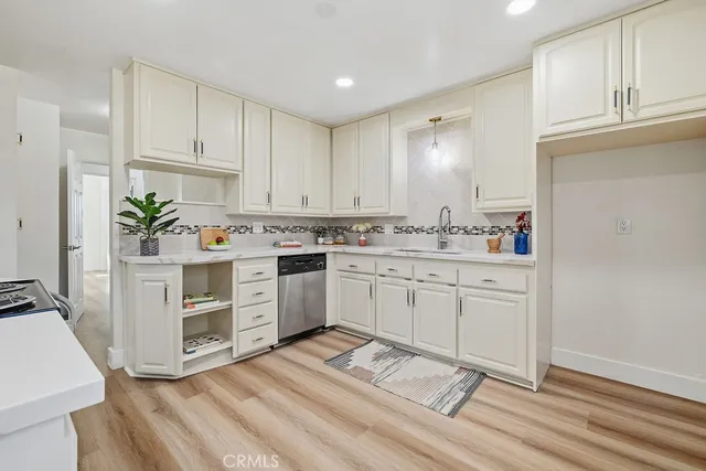 a kitchen with white cabinets and white appliances