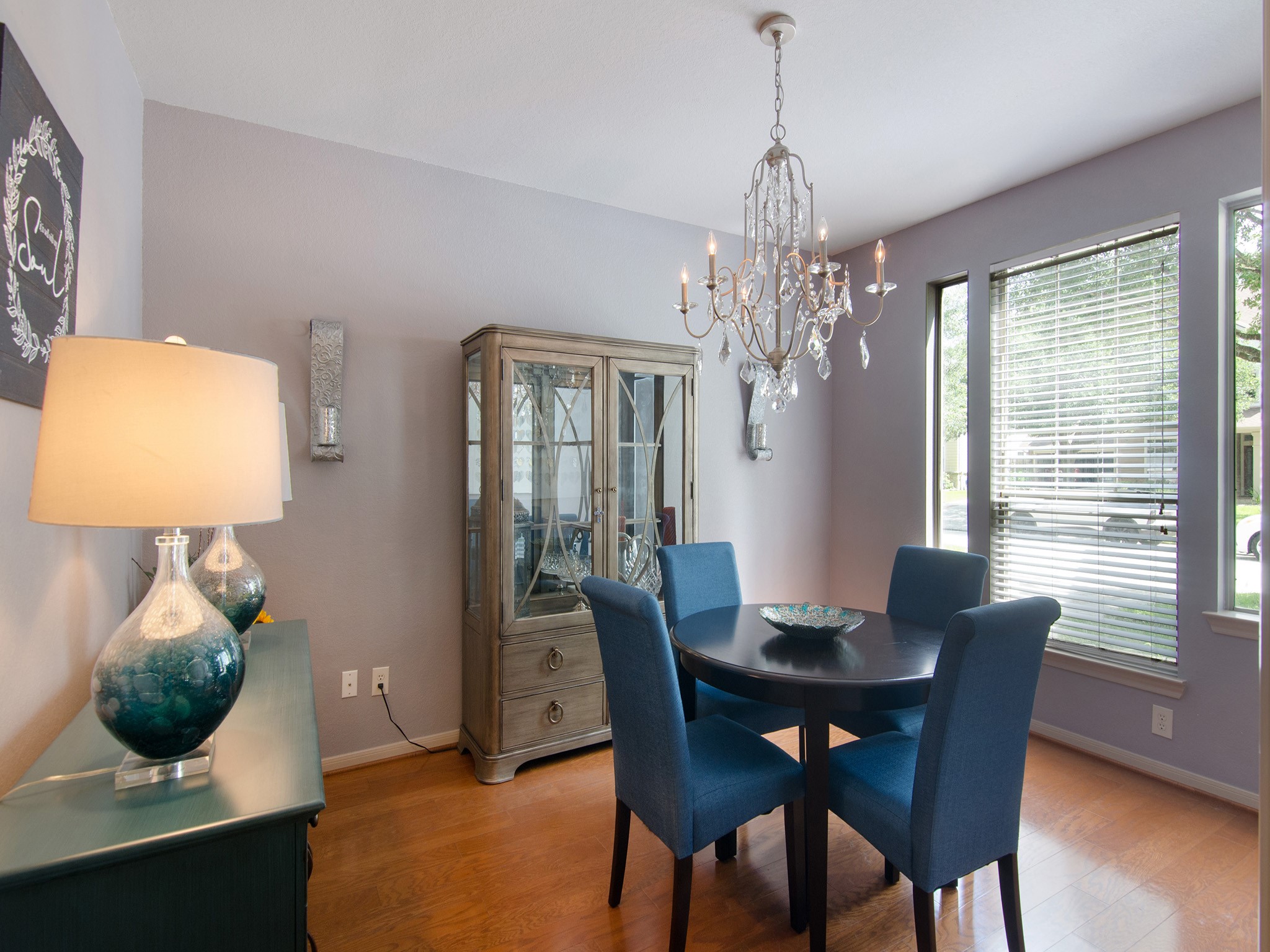 28323 Ryans Ridge Lane Spring, TX 77386 - Photo 6 of 45 The formal dining room combines elegance and warmth with rich wood flooring, an eye-catching chandelier and large windows that fill the space with natural light, creating the perfect setting for holiday gatherings and special occasions.