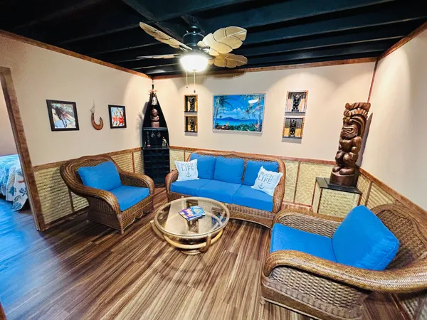 a living room with furniture and a wooden floor