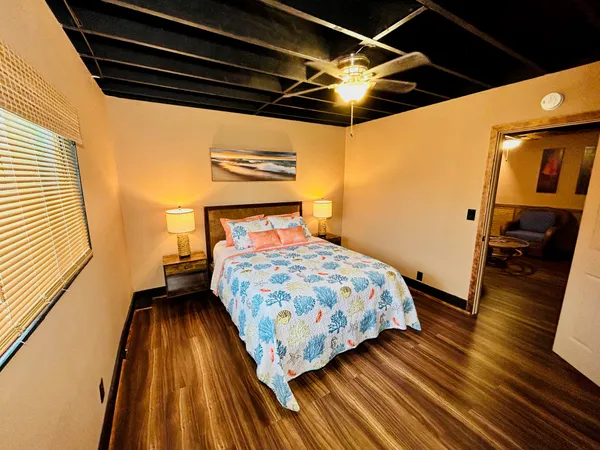 a bedroom with a bed and wooden floor