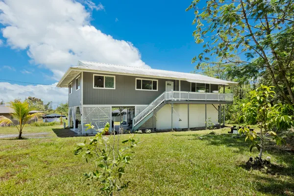 a view of house with yard