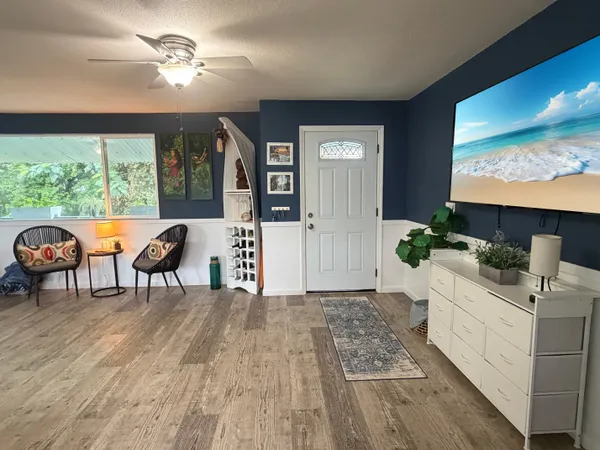 a living room with furniture and a flat screen tv