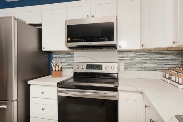 a kitchen with a stove and a microwave