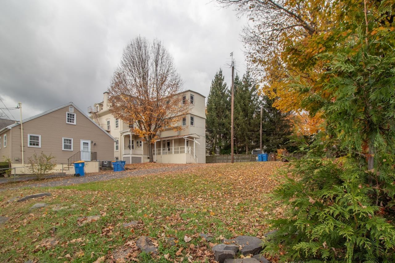 Undisclosed Address Kingston, NY 12401 - Photo 14 of 33 a front view of a house with a yard and trees