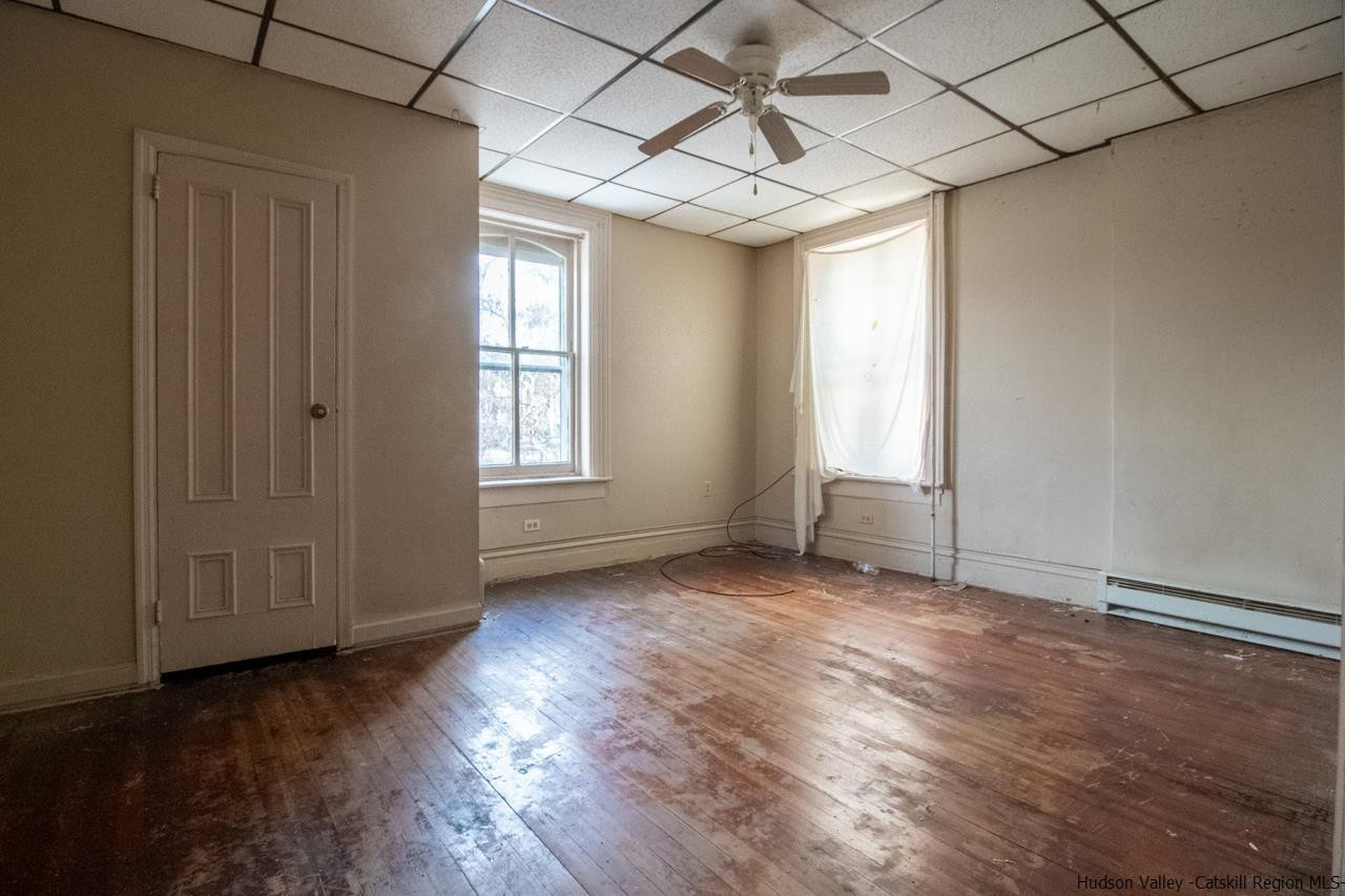 Undisclosed Address Kingston, NY 12401 - Photo 20 of 33 an empty room with wooden floor and windows