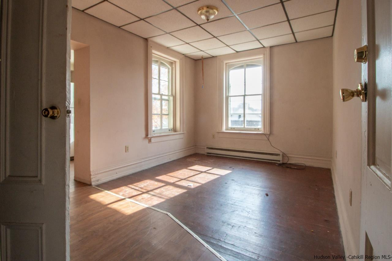Undisclosed Address Kingston, NY 12401 - Photo 24 of 33 an empty room with wooden floor and windows