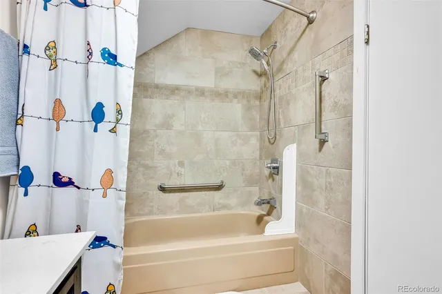a view of a livingroom with bookshelf and a window