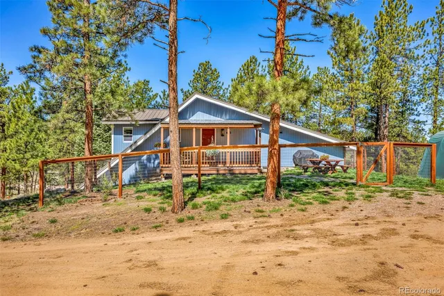 a view of a wooden house with a yard