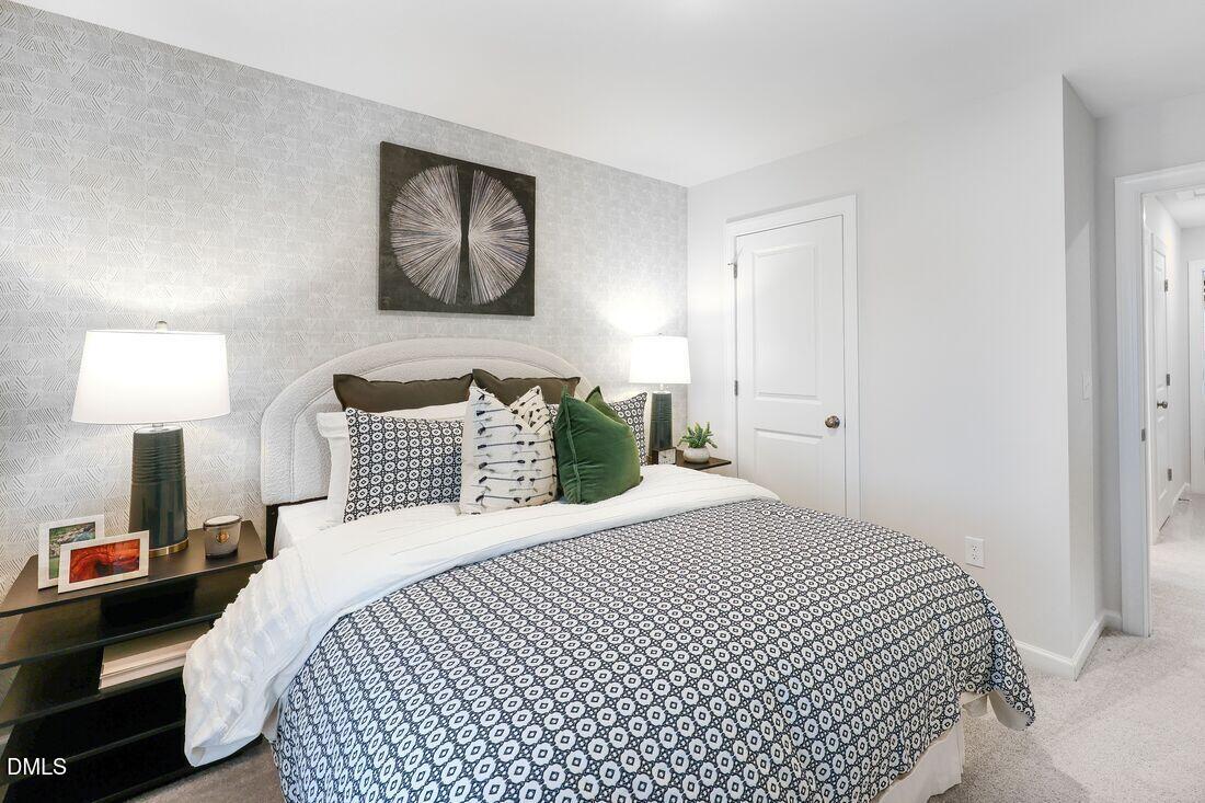 1324 West Garner Road, Unit 100 Garner, NC 27529 - Photo 25 of 34 a bedroom with a bed and a lamp on table
