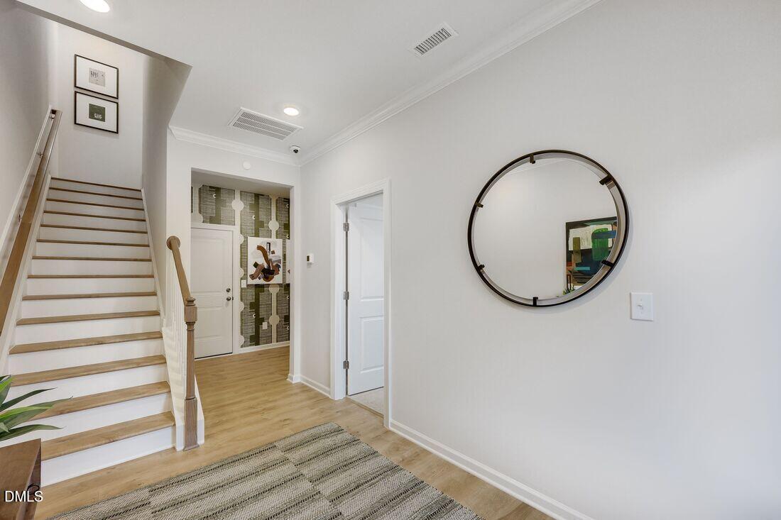 1324 West Garner Road, Unit 100 Garner, NC 27529 - Photo 6 of 34 a view of a hallway with wooden floor and entryway