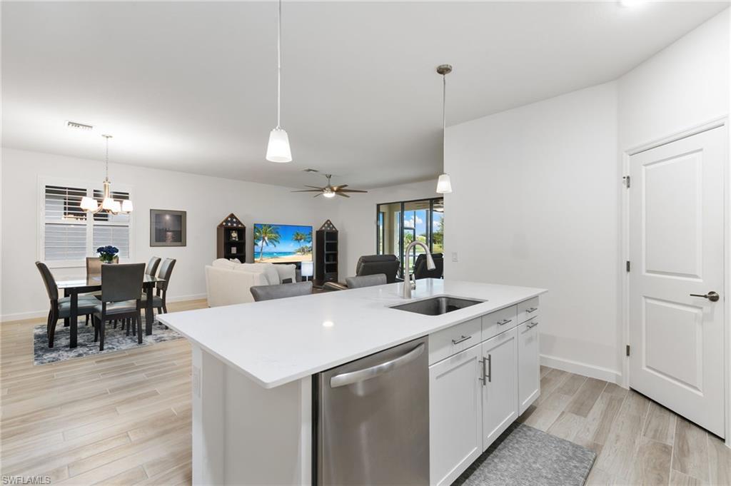 1473 Birdie Drive Naples, FL 34120 - Photo 13 of 50 a kitchen with a sink a counter space and wooden floor