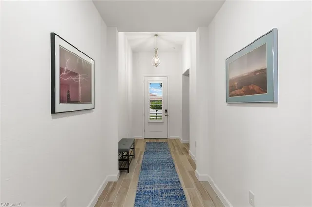 a view of a hallway with wooden floor
