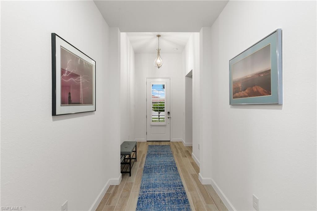 1473 Birdie Drive Naples, FL 34120 - Photo 14 of 50 a view of a hallway with wooden floor