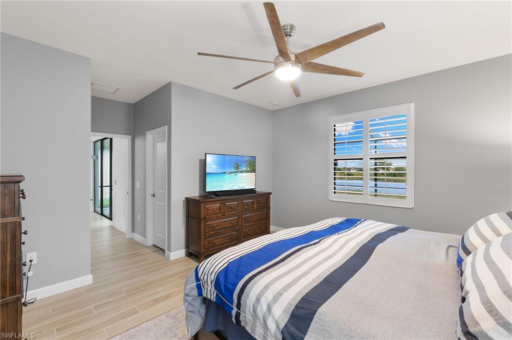 1473 Birdie Drive Naples, FL 34120 - Photo 16 of 50 a bedroom with a bed and a dresser