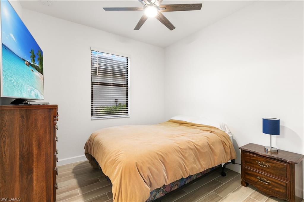 1473 Birdie Drive Naples, FL 34120 - Photo 20 of 50 a bedroom with a bed and a window