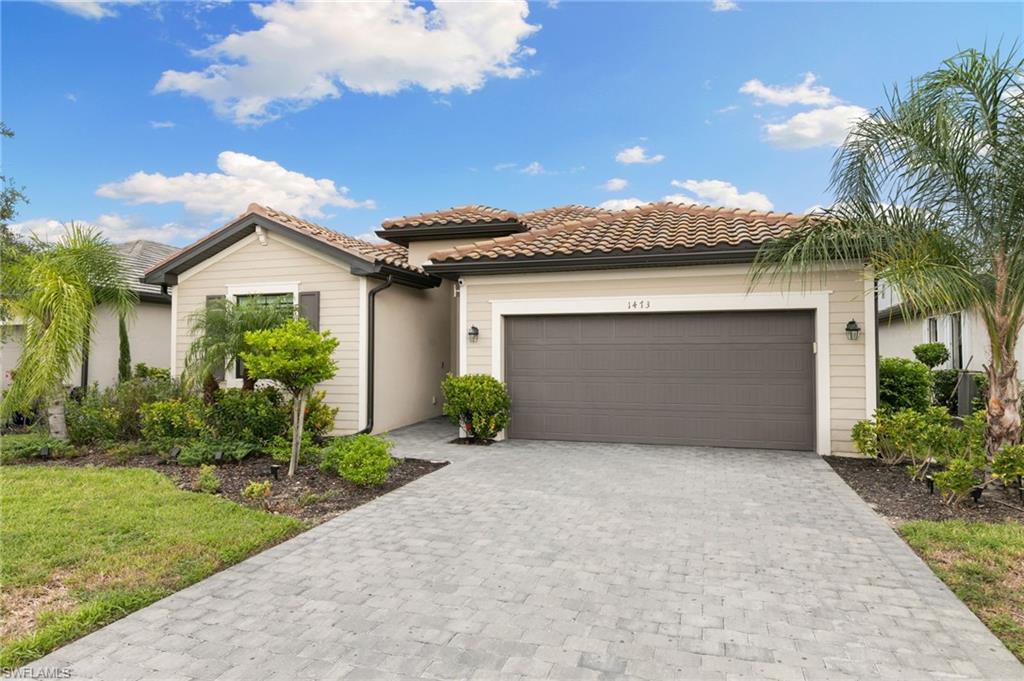 1473 Birdie Drive Naples, FL 34120 - Photo 2 of 50 a front view of a house with garden