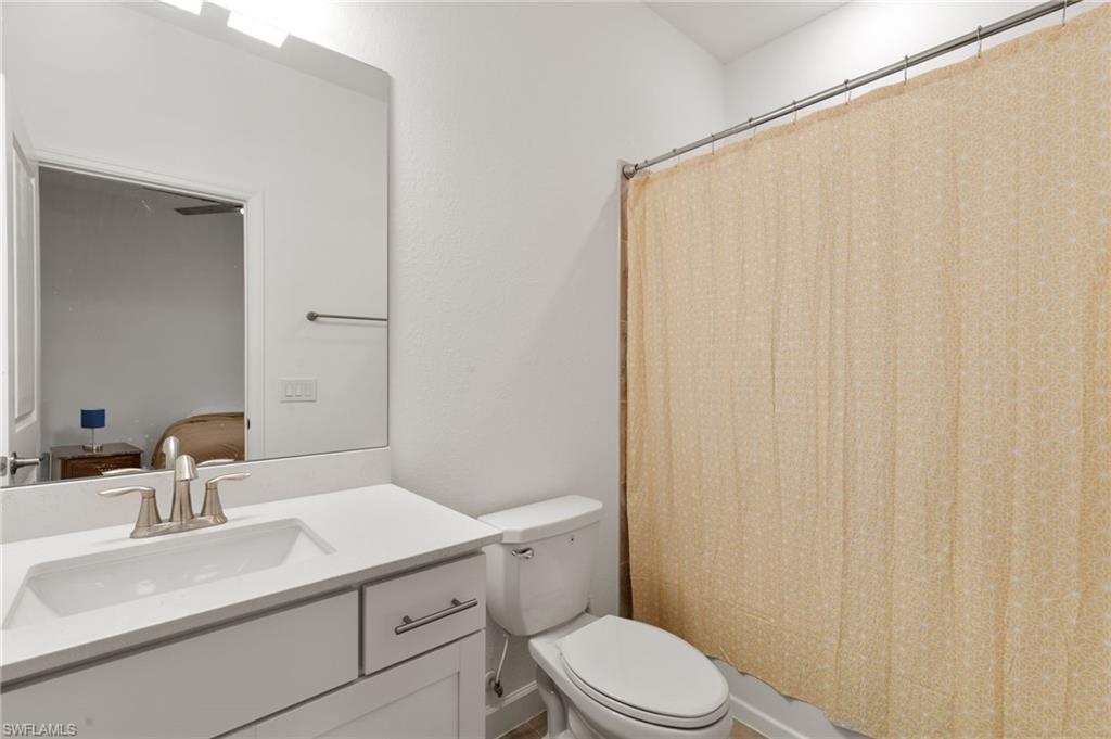 1473 Birdie Drive Naples, FL 34120 - Photo 21 of 50 a bathroom with a sink a toilet and shower