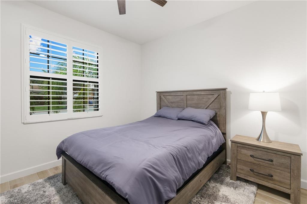 1473 Birdie Drive Naples, FL 34120 - Photo 22 of 50 a bedroom with a bed and a window
