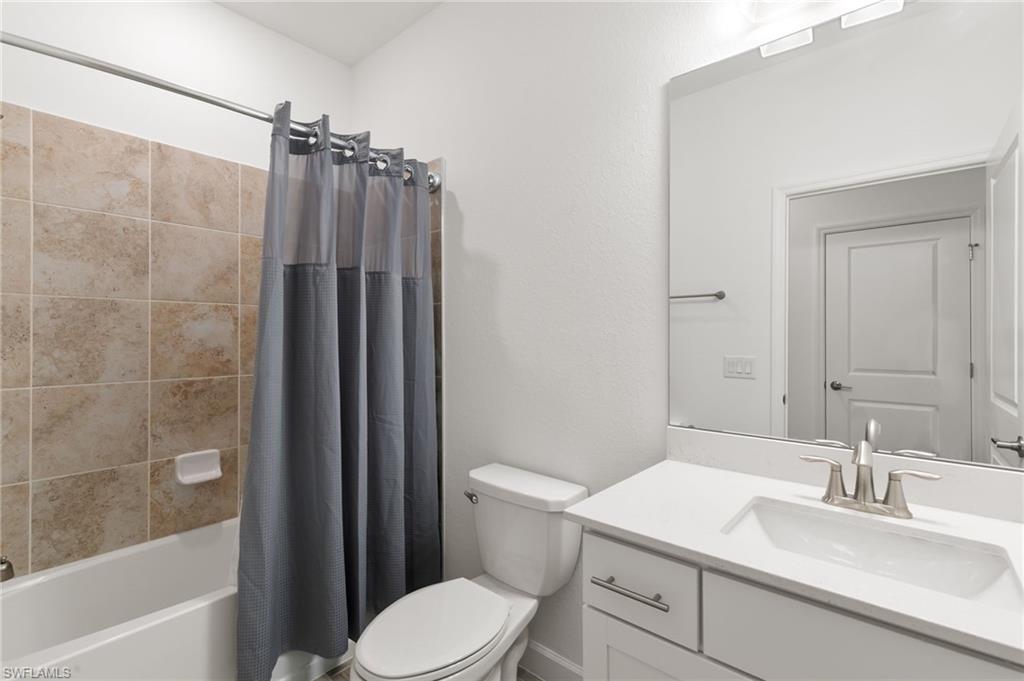 1473 Birdie Drive Naples, FL 34120 - Photo 24 of 50 a bathroom with a sink a toilet a mirror and shower