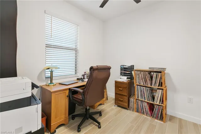 a view of a workspace with furniture and a window