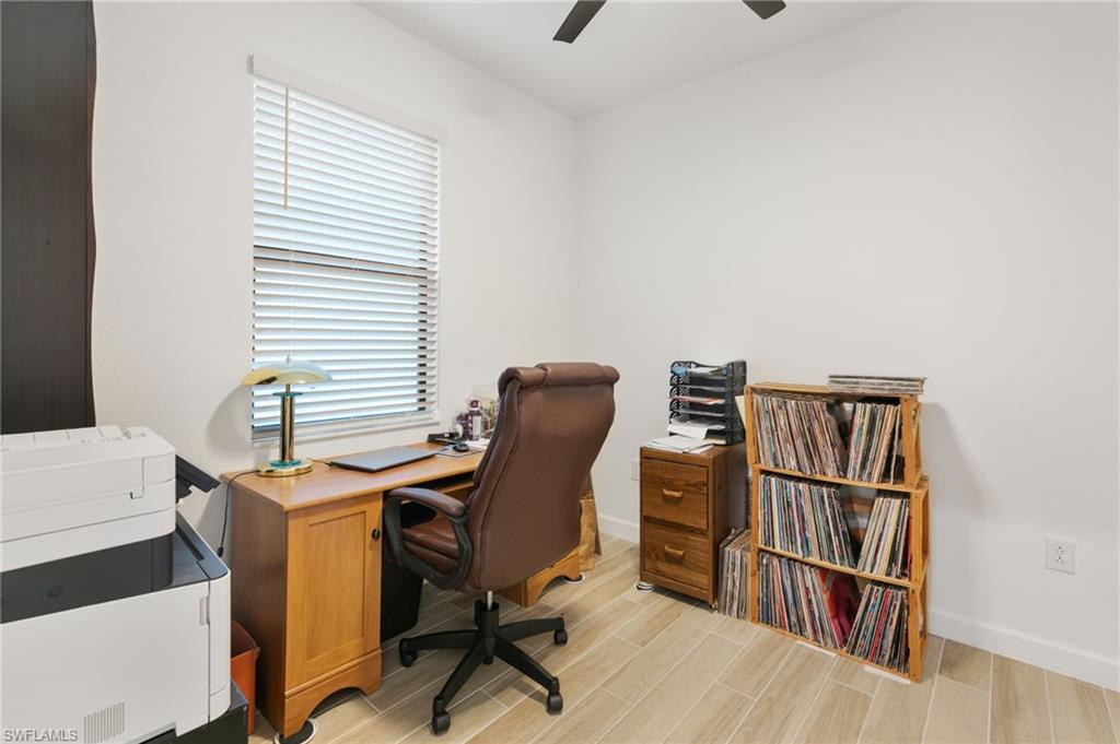 1473 Birdie Drive Naples, FL 34120 - Photo 25 of 50 a view of a workspace with furniture and a window