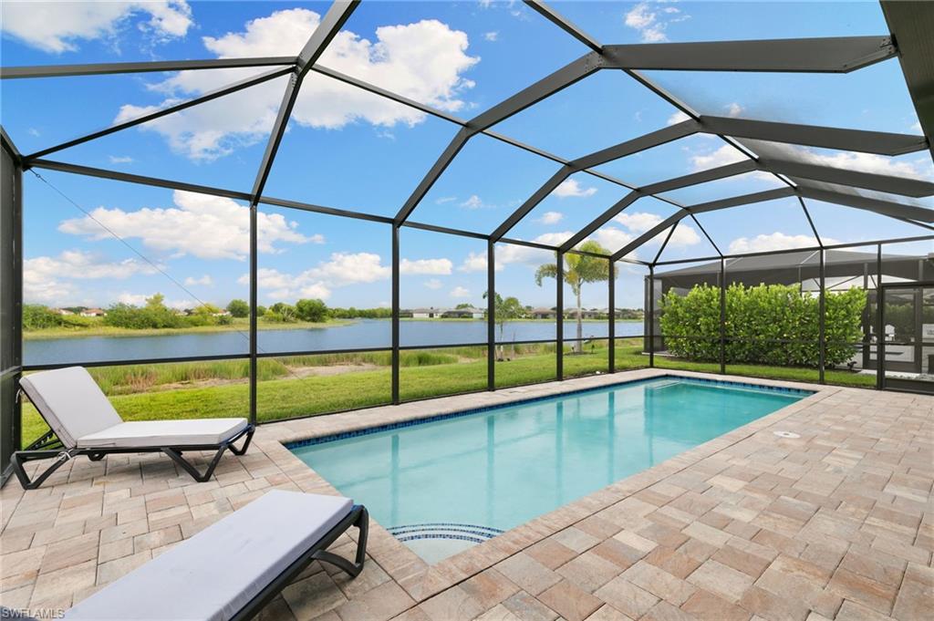 1473 Birdie Drive Naples, FL 34120 - Photo 29 of 50 a view of a swimming pool with a porch