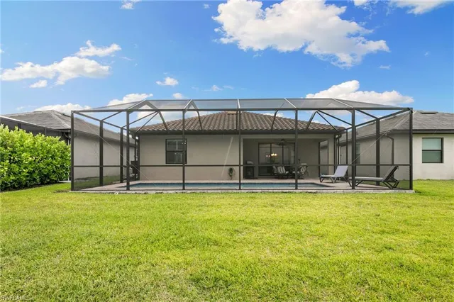 a view of a house with swimming pool and a yard