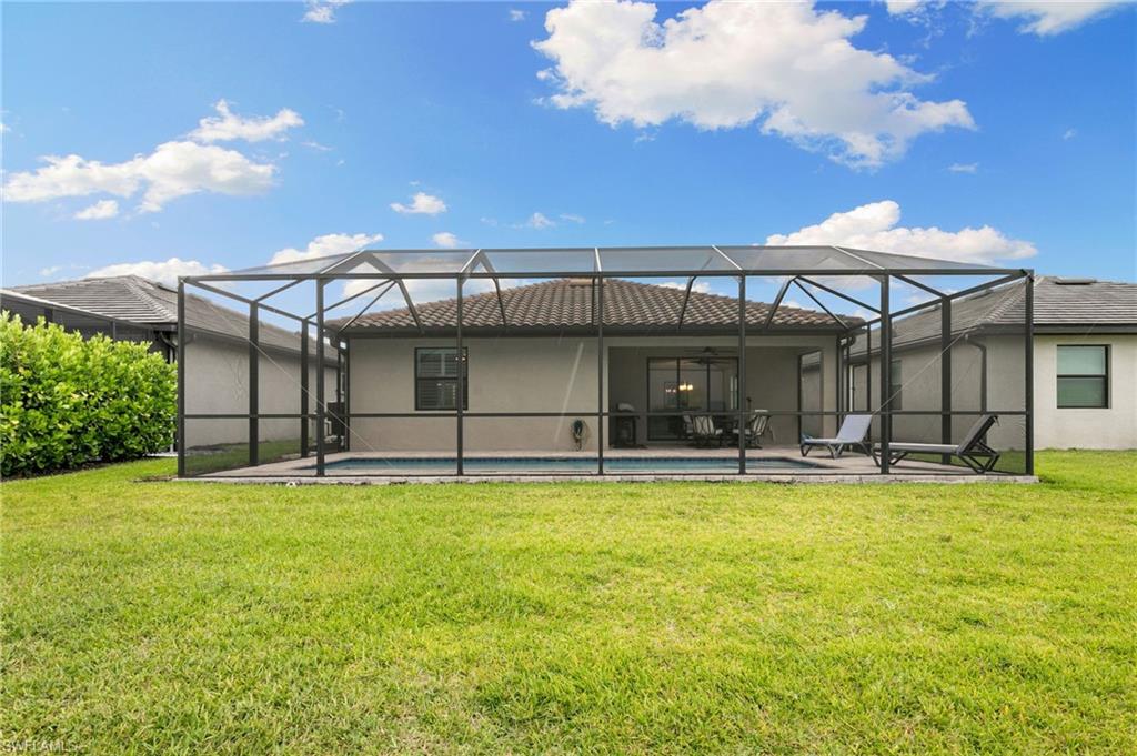 1473 Birdie Drive Naples, FL 34120 - Photo 33 of 50 a view of a house with swimming pool and a yard