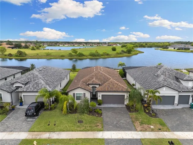 an aerial view of a house with a garden and lake view