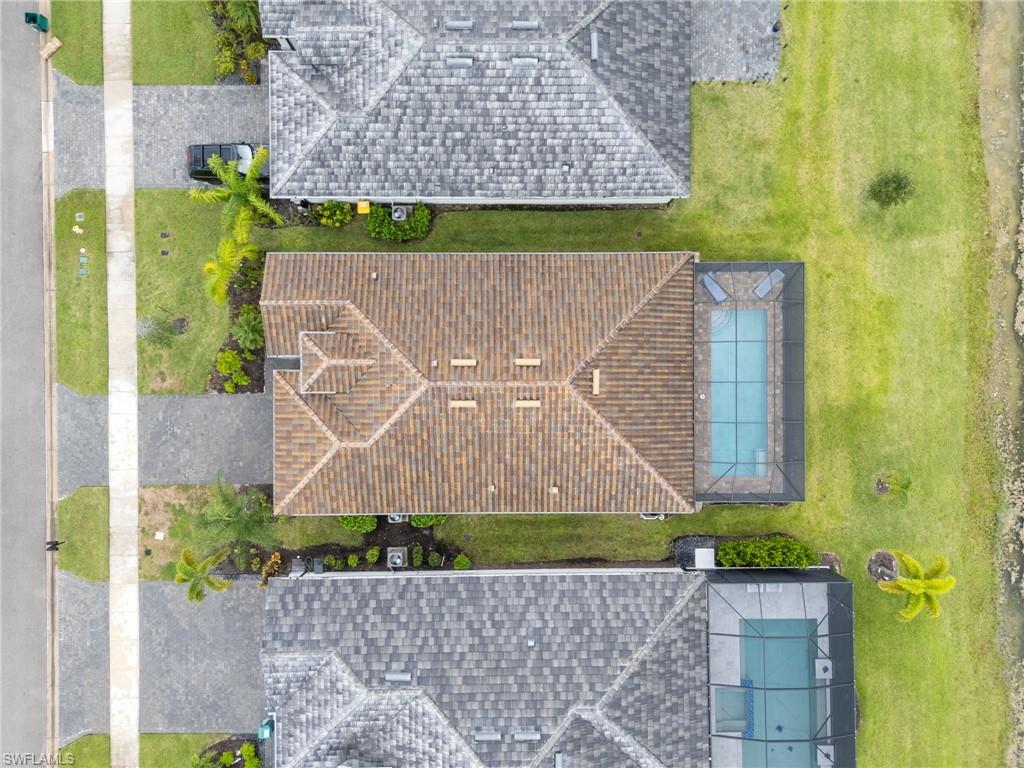 1473 Birdie Drive Naples, FL 34120 - Photo 40 of 50 front view of a brick house with a yard