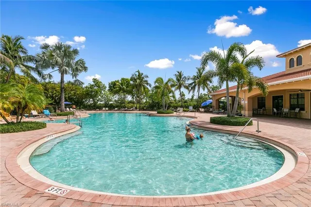 a swimming pool with outdoor seating and yard